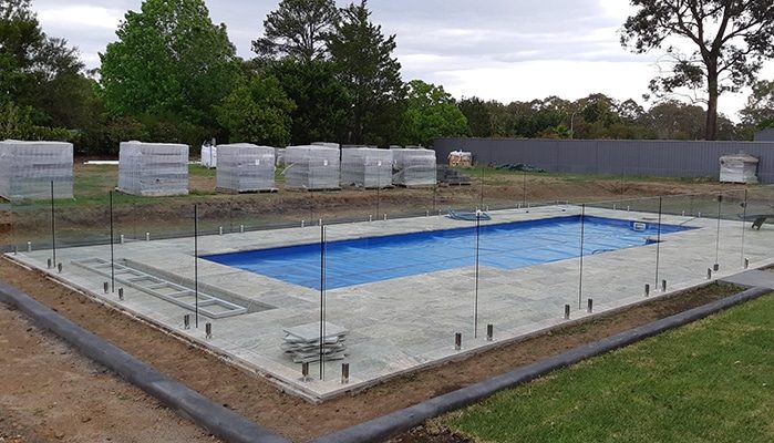 A Pool with Glass Fencing — Pool Cover Systems in Nowra, NSW