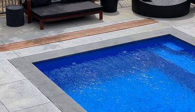 Comfortable Couch Beside the Pool — Pool Cover Systems in Nowra, NSW
