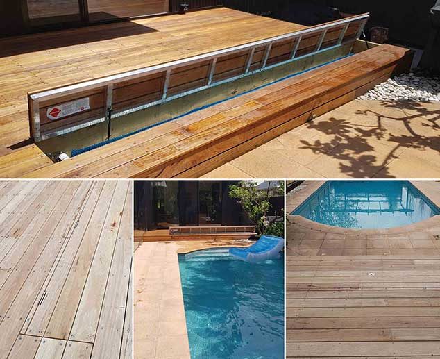 A Pool With A Wooden Deck And Fence — Pool Cover Systems in Nowra, NSW