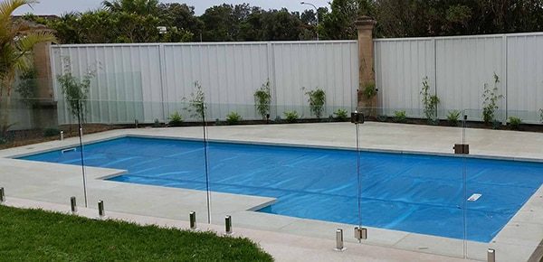 A Clean Pool with Glass Fence — Pool Cover Systems in Perth, WA